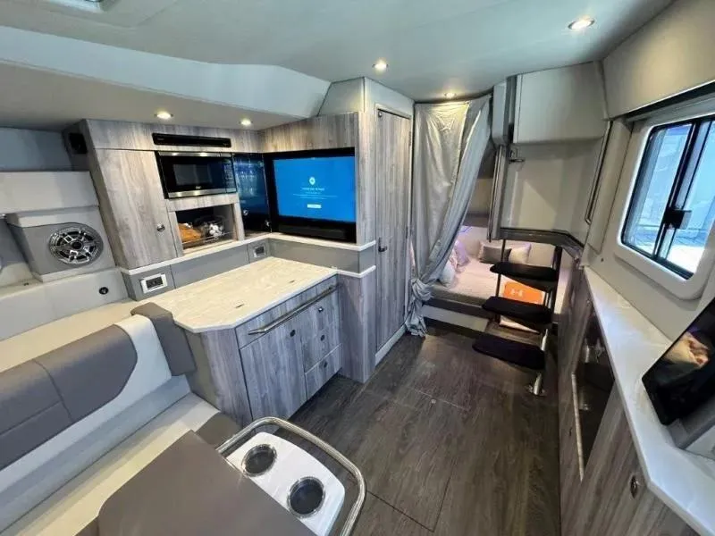 Slide: The Image of Interior of 2022 Formula 430 Super Sport Crossover with modern kitchen and cozy seating area. - 18