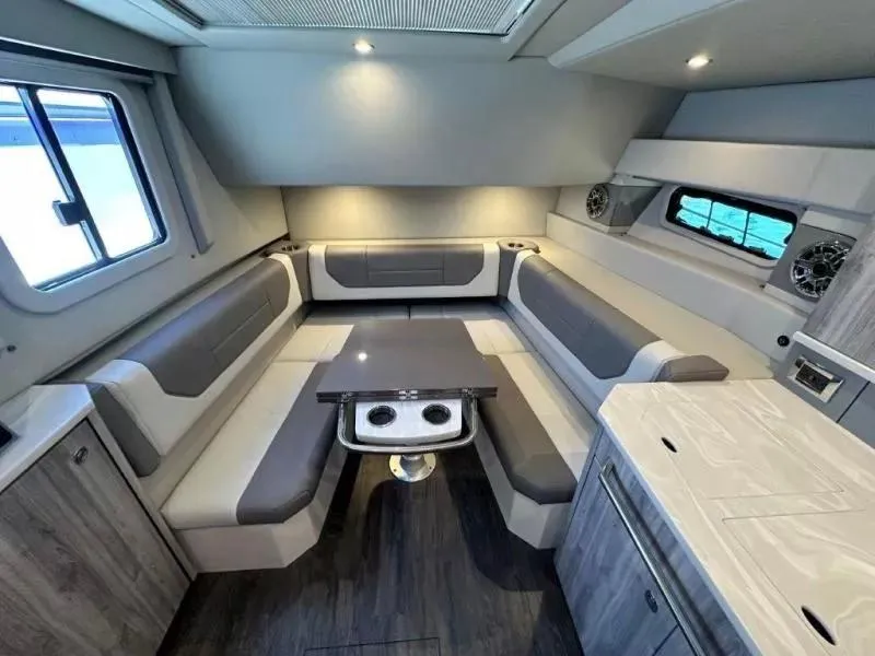 Slide: The Image of 2022 Formula 430 Super Sport Crossover interior with modern seating and table setup. - 19