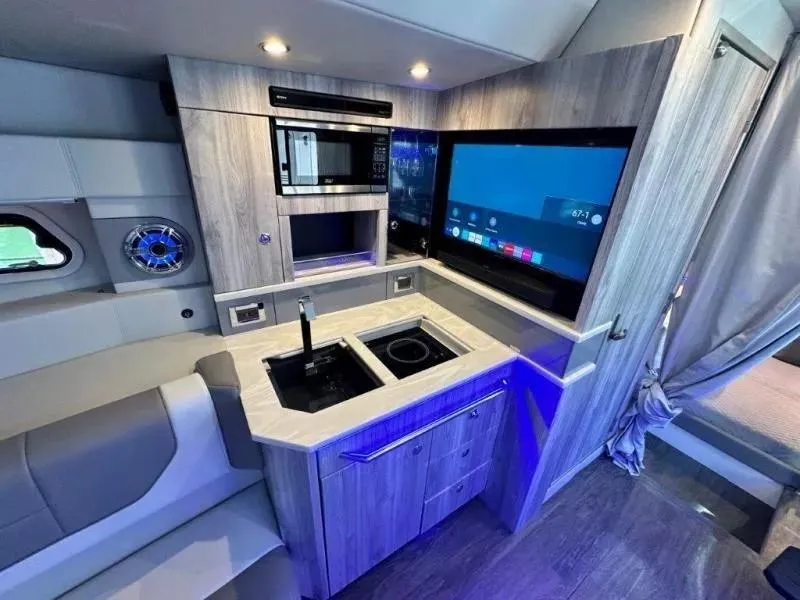 Slide: The Image of Modern kitchen interior in 2022 Formula 430 Super Sport Crossover boat, featuring sleek appliances. - 22