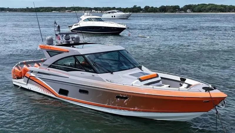 Slide: The Image of 2022 Formula 430 Super Sport Crossover boat on water, sleek design, vibrant orange accents. - 5