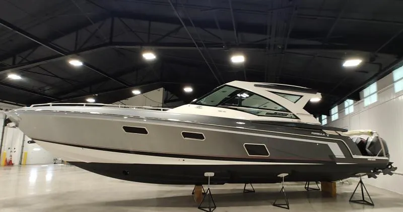 Slide: The Image of 2021 Formula 430 Super Sport Crossover boat displayed in a spacious indoor showroom. - 1