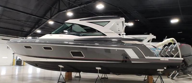 Slide: The Image of 2021 Formula 430 Super Sport Crossover boat displayed indoors on stands. - 2