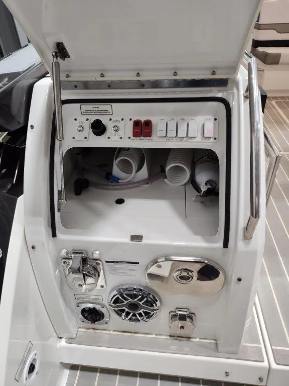 Slide: The Image of 2021 Formula 430 Super Sport Crossover control panel with switches and storage compartment. - 25