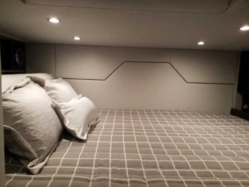 Slide: The Image of 2021 Formula 430 Super Sport Crossover cabin with cozy bed and modern lighting. - 9