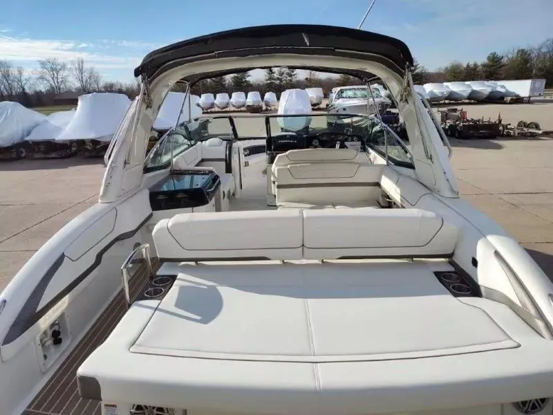 Slide: The Image of 2018 Formula 350 Crossover Bowrider with spacious seating and sleek design, docked outdoors. - 10