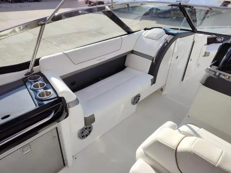 Slide: The Image of 2018 Formula 350 Crossover Bowrider interior with white seating and cup holders. - 12
