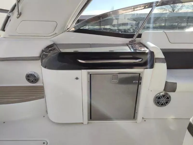 Slide: The Image of 2018 Formula 350 Crossover Bowrider interior with sleek cabinetry and stainless steel accents. - 20