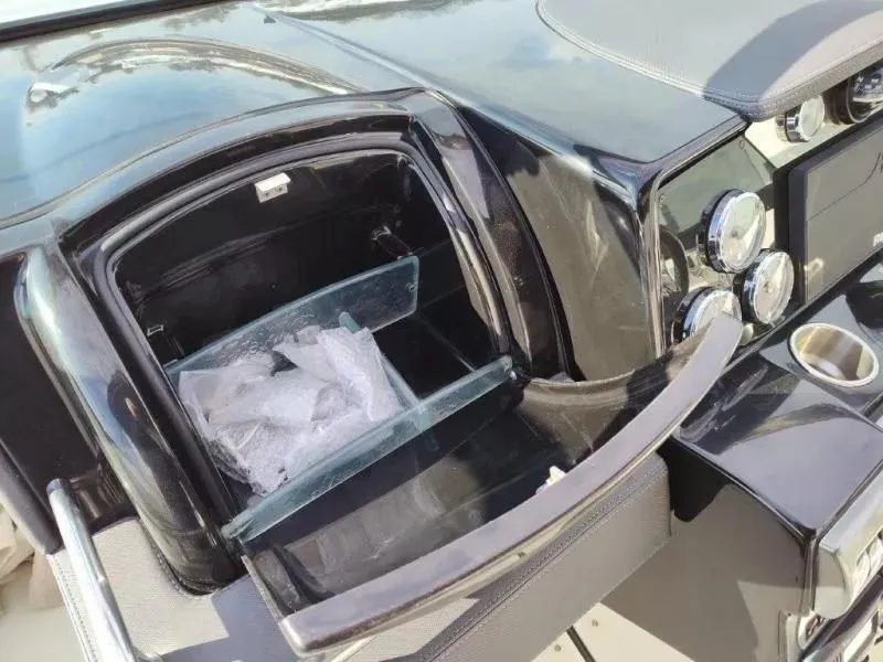 Slide: The Image of 2018 Formula 350 Crossover Bowrider dashboard with open storage compartment and controls. - 24