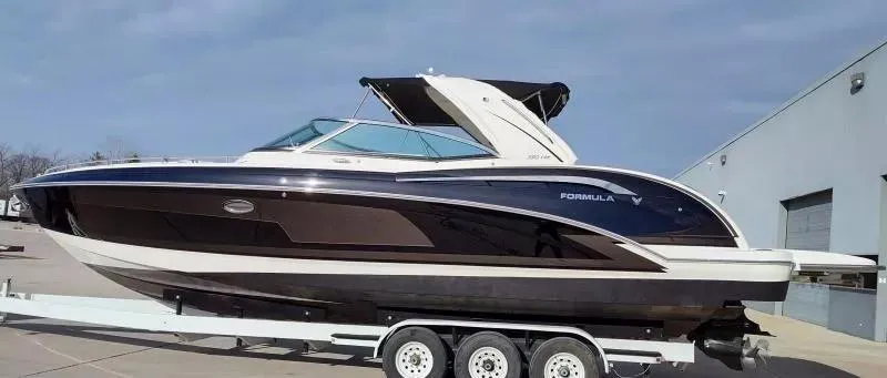 Slide: The Image of 2018 Formula 350 Crossover Bowrider on trailer, sleek design, parked outdoors. - 3