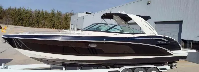 Slide: The Image of 2018 Formula 350 Crossover Bowrider boat on trailer, parked outdoors. - 6