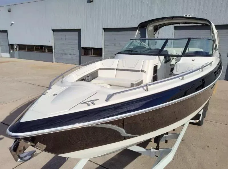 Slide: The Image of 2018 Formula 350 Crossover Bowrider boat on trailer, parked outside a warehouse. - 7