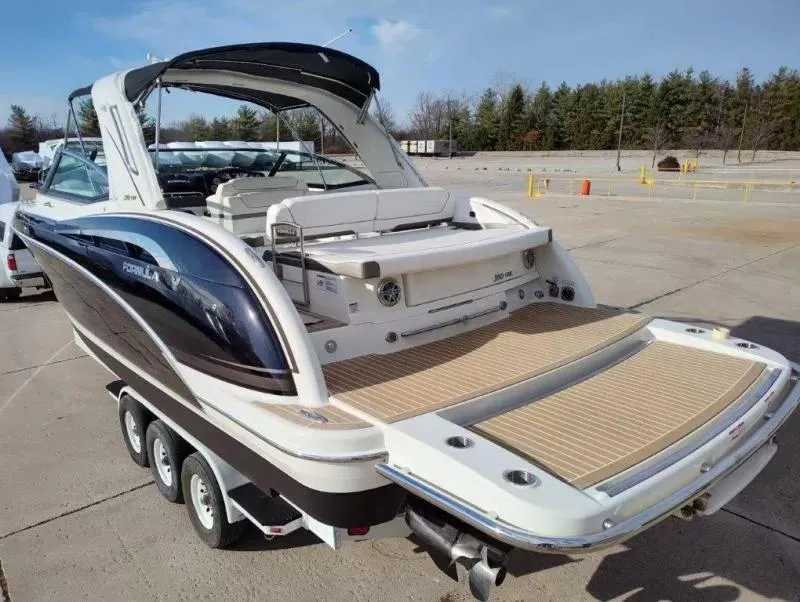 Slide: The Image of 2018 Formula 350 Crossover Bowrider boat on trailer, rear view, in parking lot. - 8