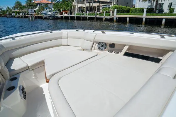 Slide: The Image of 2020 Boston Whaler 350 Realm boat with spacious seating area and waterfront view. - 4