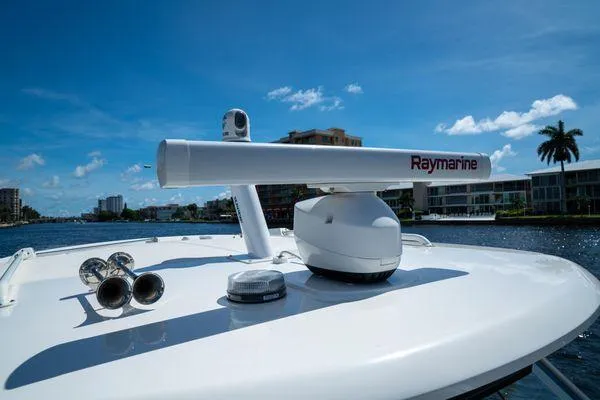 Slide: The Image of Boston Whaler 350 Realm 2020 boat with Raymarine radar on deck, under clear blue sky. - 6