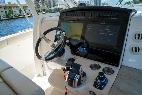 Slide: The Image of Helm of 2020 Boston Whaler 350 Realm with advanced navigation system and controls. - 7