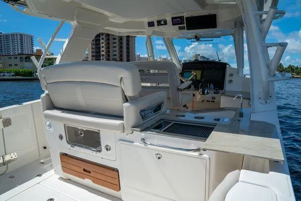 Slide: The Image of 2020 Boston Whaler 350 Realm boat interior with helm and seating area. - 8