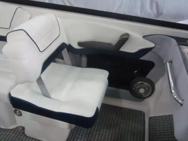 Slide: The Image of 2014 Formula 270 Bowrider interior seating with white upholstery and blue accents. - 11