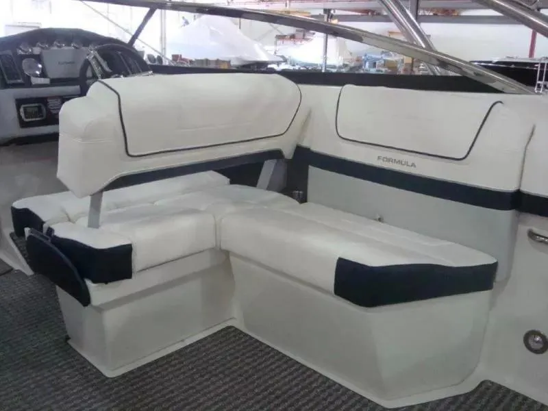 Slide: The Image of 2014 Formula 270 Bowrider interior with white cushioned seating and sleek design. - 14