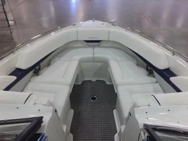 Slide: The Image of 2014 Formula 270 Bowrider boat interior with white seating and gray flooring. - 3