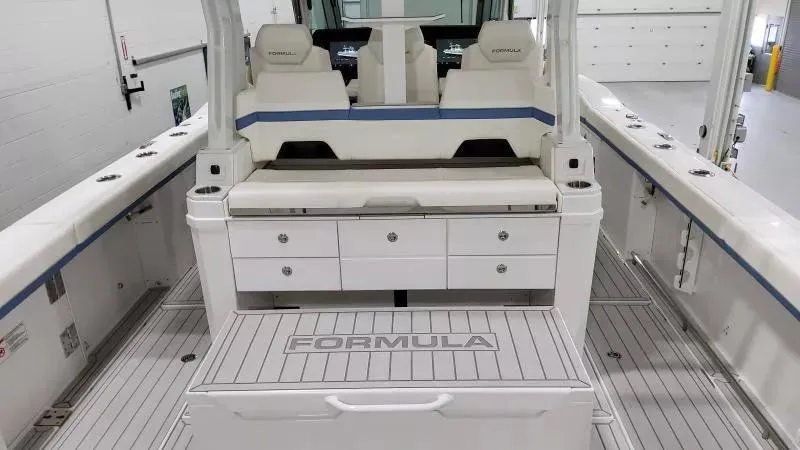 Slide: The Image of 2025 Formula 387 Center Console Fish boat interior with seating and storage compartments. - 15