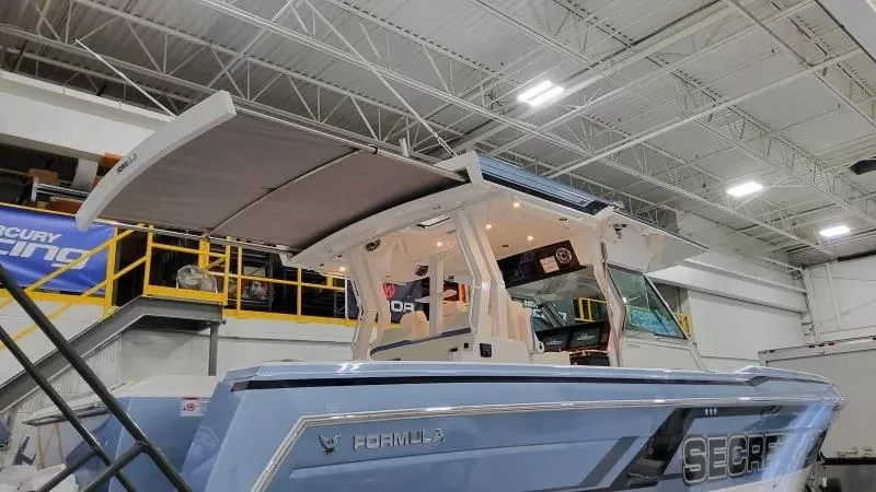 Slide: The Image of 2025 Formula 387 Center Console Fish boat in a showroom, featuring sleek design and modern amenities. - 16