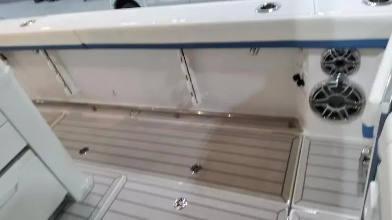 Slide: The Image of 2025 Formula 387 Center Console Fish boat interior with speakers and storage compartments. - 17