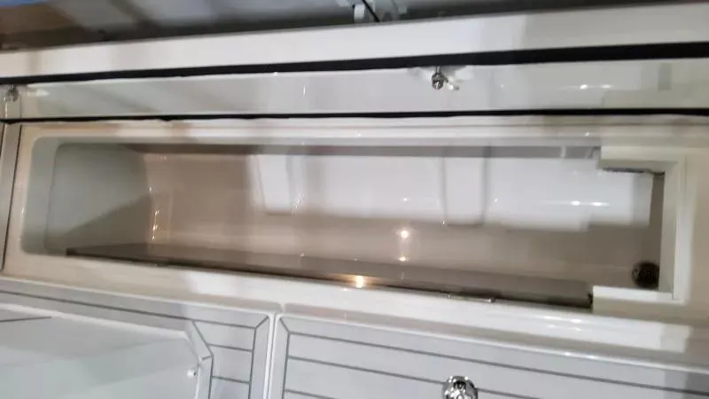 Slide: The Image of 2025 Formula 387 Center Console Fish storage compartment, open and empty, showcasing sleek design. - 18