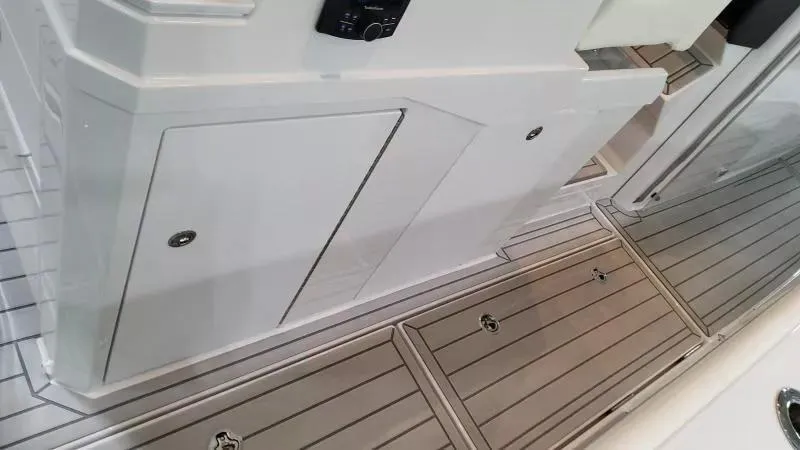 Slide: The Image of 2025 Formula 387 Center Console Fish boat interior with sleek white cabinetry and teak-style flooring. - 21