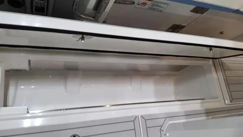 Slide: The Image of 2025 Formula 387 Center Console Fish storage compartment, open and empty, showcasing interior design. - 24