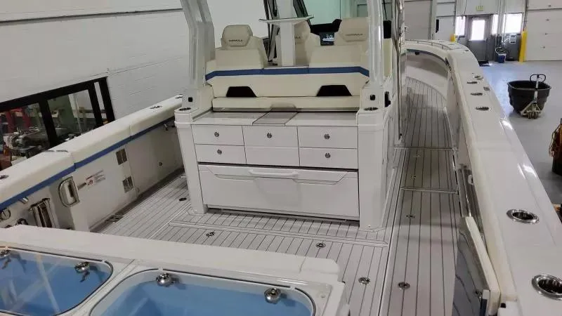 Slide: The Image of 2025 Formula 387 Center Console Fish boat interior with seating and storage compartments. - 8