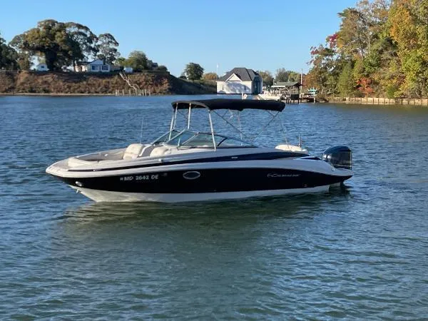 Slide: The Image of 2017 Crownline Eclipse E6 XS boat on a calm lake with scenic background. - 1