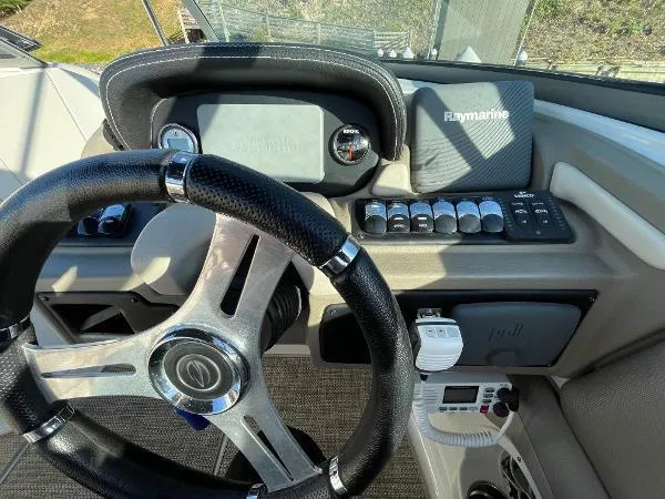 Slide: The Image of 2017 Crownline Eclipse E6 XS boat dashboard with steering wheel and Raymarine electronics. - 10