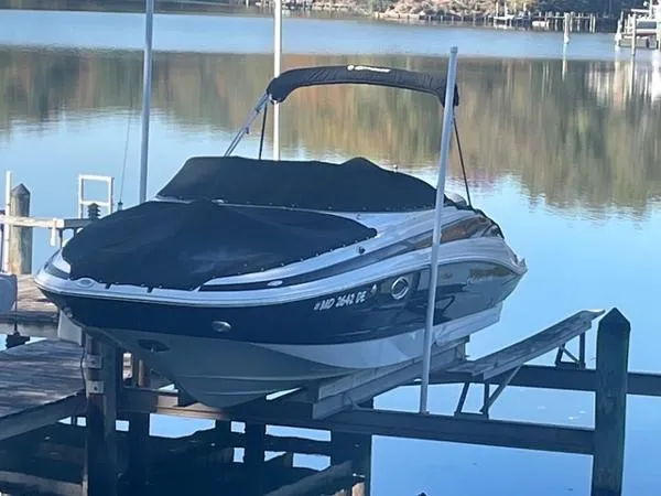 Slide: The Image of 2017 Crownline Eclipse E6 XS boat docked on a serene lake. - 2