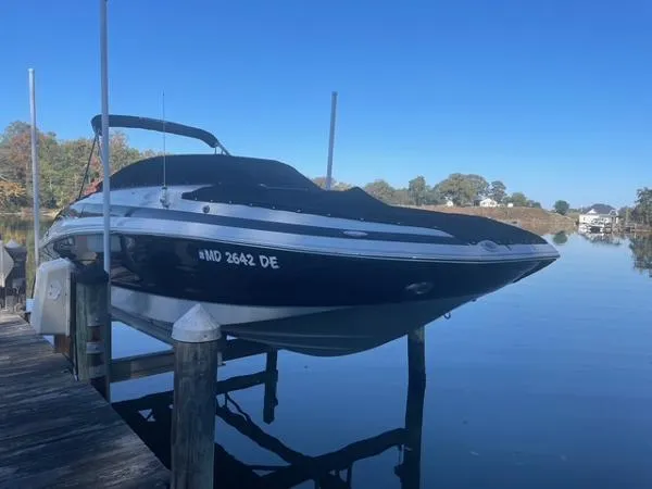 Slide: The Image of 2017 Crownline Eclipse E6 XS boat docked on a calm lake under clear blue skies. - 3