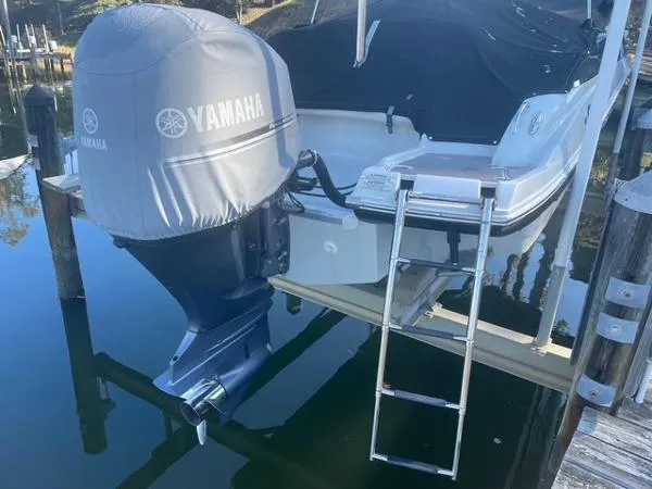 Slide: The Image of 2017 Crownline Eclipse E6 XS boat with Yamaha outboard motor and swim ladder. - 4