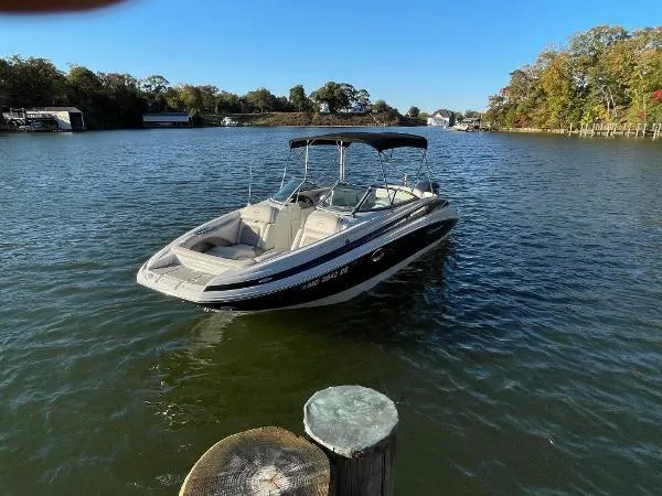 Slide: The Image of 2017 Crownline Eclipse E6 XS boat on a calm lake with trees in the background. - 7