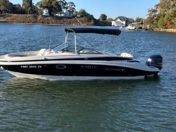 Slide: The Image of 2017 Crownline Eclipse E6 XS boat on a calm lake with scenic background. - 9