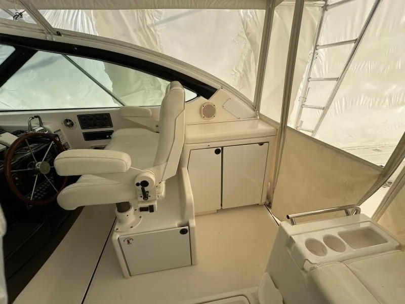 Slide: The Image of 2004 Tiara Sport 4200 Open yacht helm with white seating and steering wheel. - 18