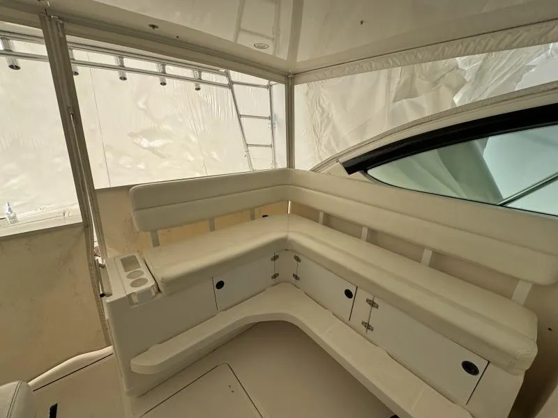 Slide: The Image of 2004 Tiara Sport 4200 Open yacht interior with white seating and storage cabinets. - 22