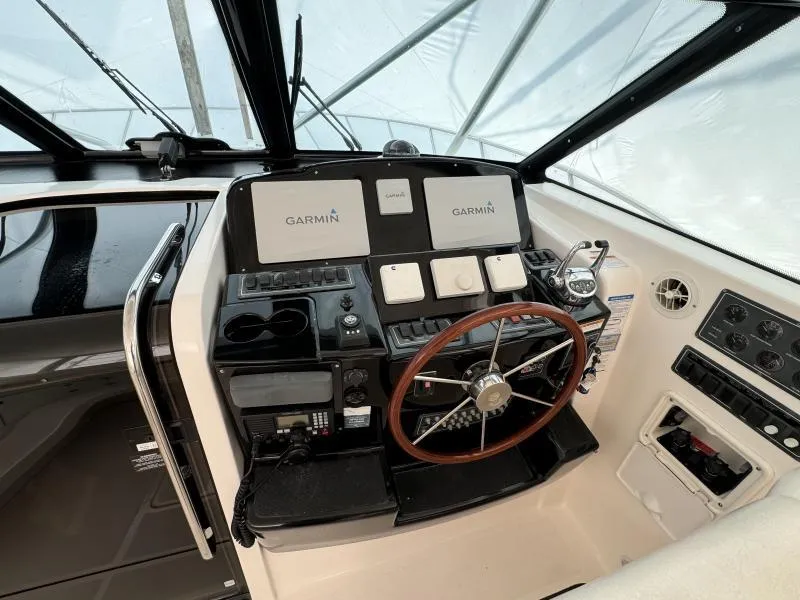 Slide: The Image of Helm of 2004 Tiara Sport 4200 Open with Garmin navigation systems and wooden steering wheel. - 24