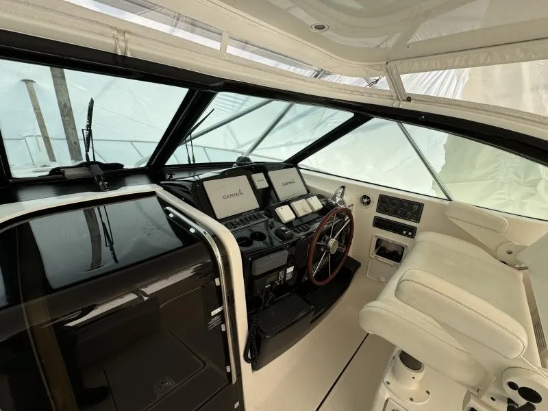 Slide: The Image of 2004 Tiara Sport 4200 Open yacht cockpit with Garmin navigation system and plush seating. - 25