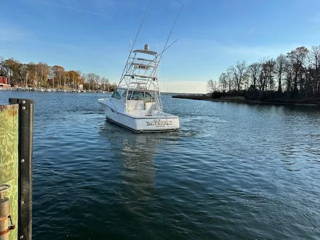 Slide: The Image of 2004 Tiara Sport 4200 Open boat on calm water near a wooded shoreline. - 7