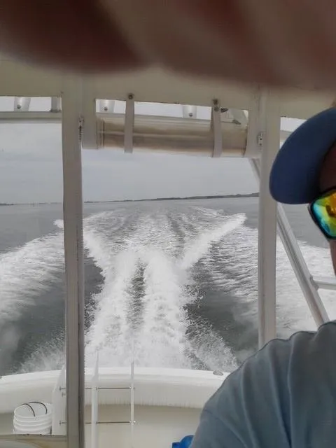 Slide: The Image of 2006 Carolina Classic 280 Express boat creating wake on open water. - 10