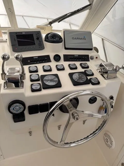 Slide: The Image of Control panel of a 2006 Carolina Classic 280 Express boat with Garmin navigation system. - 13
