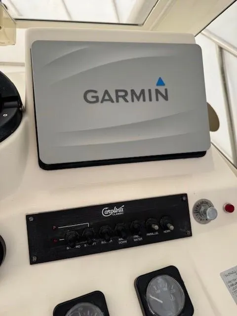 Slide: The Image of Control panel of a 2006 Carolina Classic 280 Express with Garmin navigation system. - 16
