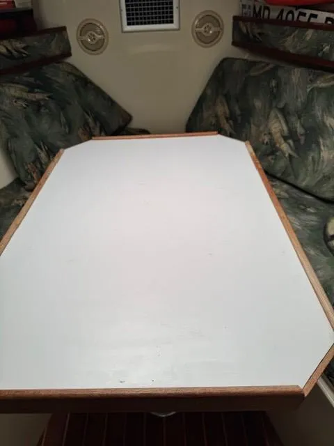 Slide: The Image of 2006 Carolina Classic 280 Express cabin interior with table and cushioned seating. - 20