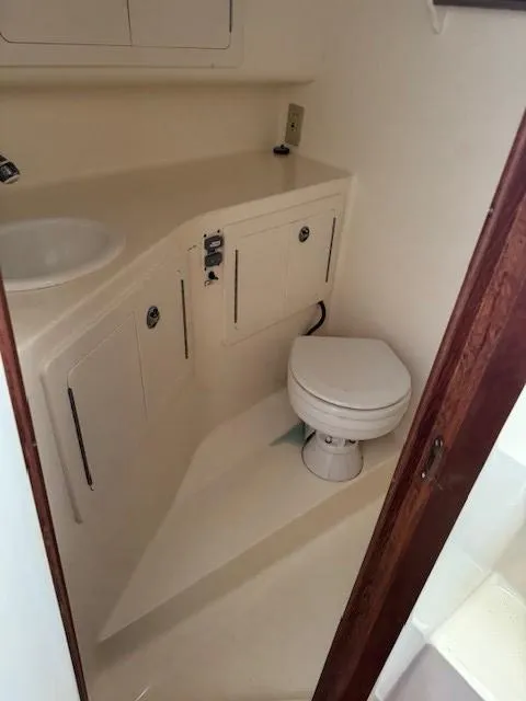 Slide: The Image of 2006 Carolina Classic 280 Express boat bathroom with sink and toilet. - 21