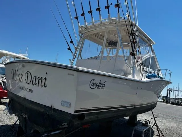 Slide: The Image of 2006 Carolina Classic 280 Express boat with fishing rods, named "Miss Dani," docked in Cambridge, MD. - 4