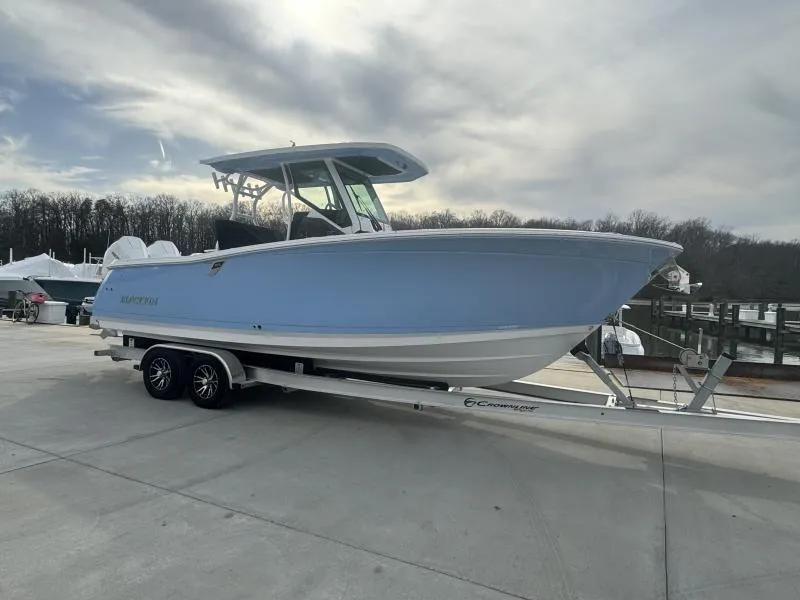 Slide: The Image of 2025 Blackfin 272 Center Console boat on trailer, parked outdoors under cloudy sky. - 1