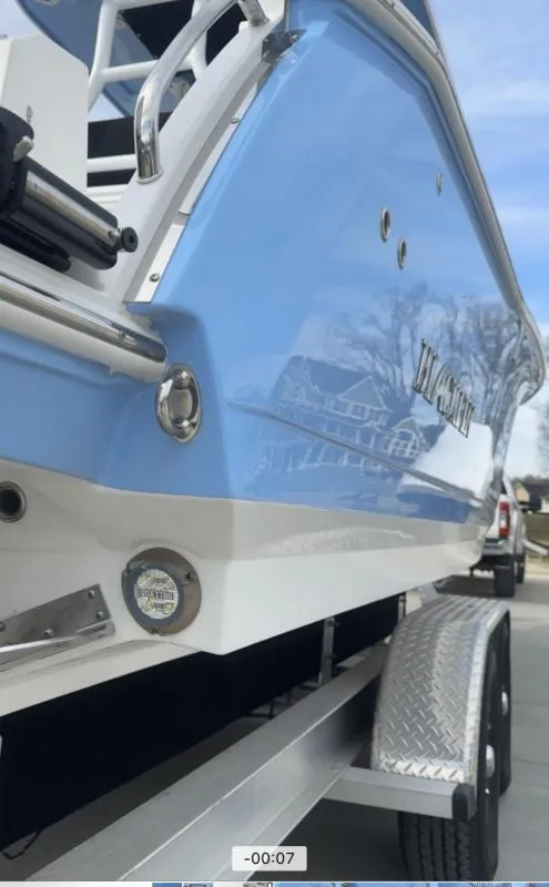 Slide: The Image of 2025 Blackfin 272 Center Console boat on trailer, showcasing sleek blue and white design. - 12